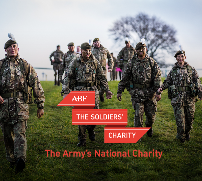 A promotional image for ABF The Soldiers charity featuring soldiers in full camouflage walking downhill. 