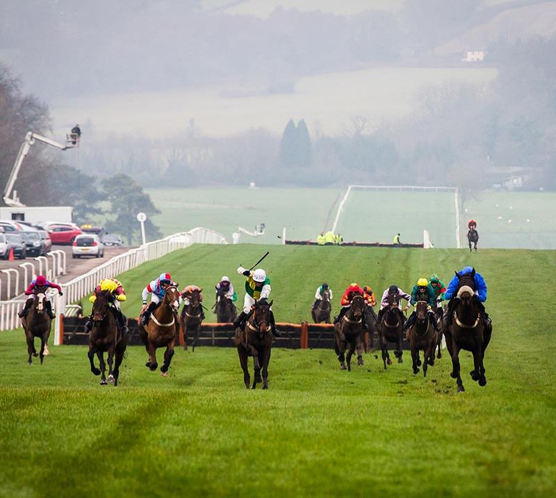 Group of jockeys racing at Chepstow Racecourse.