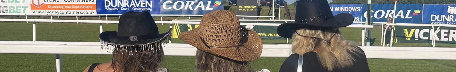 Three ladies looking out over the track at Chepstow Races