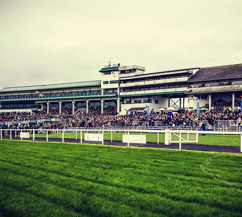 A view of a full crowd in the grandstand at Chepstow Racecourse.